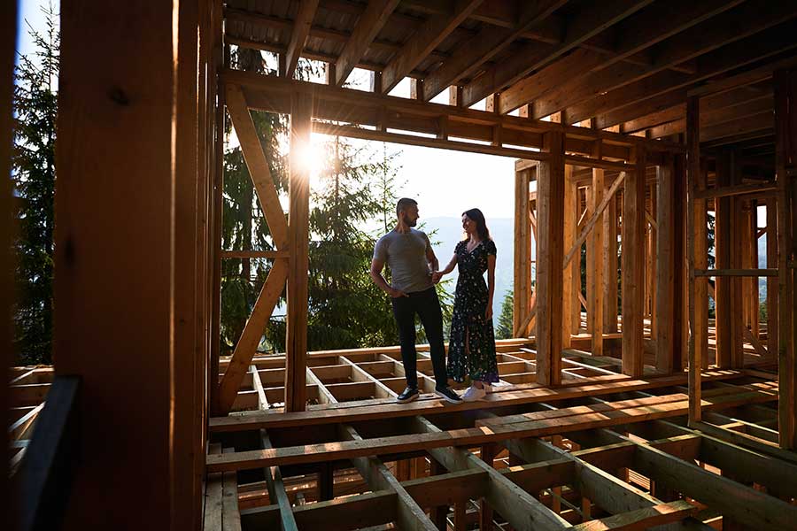 Couple walking inside of home being built